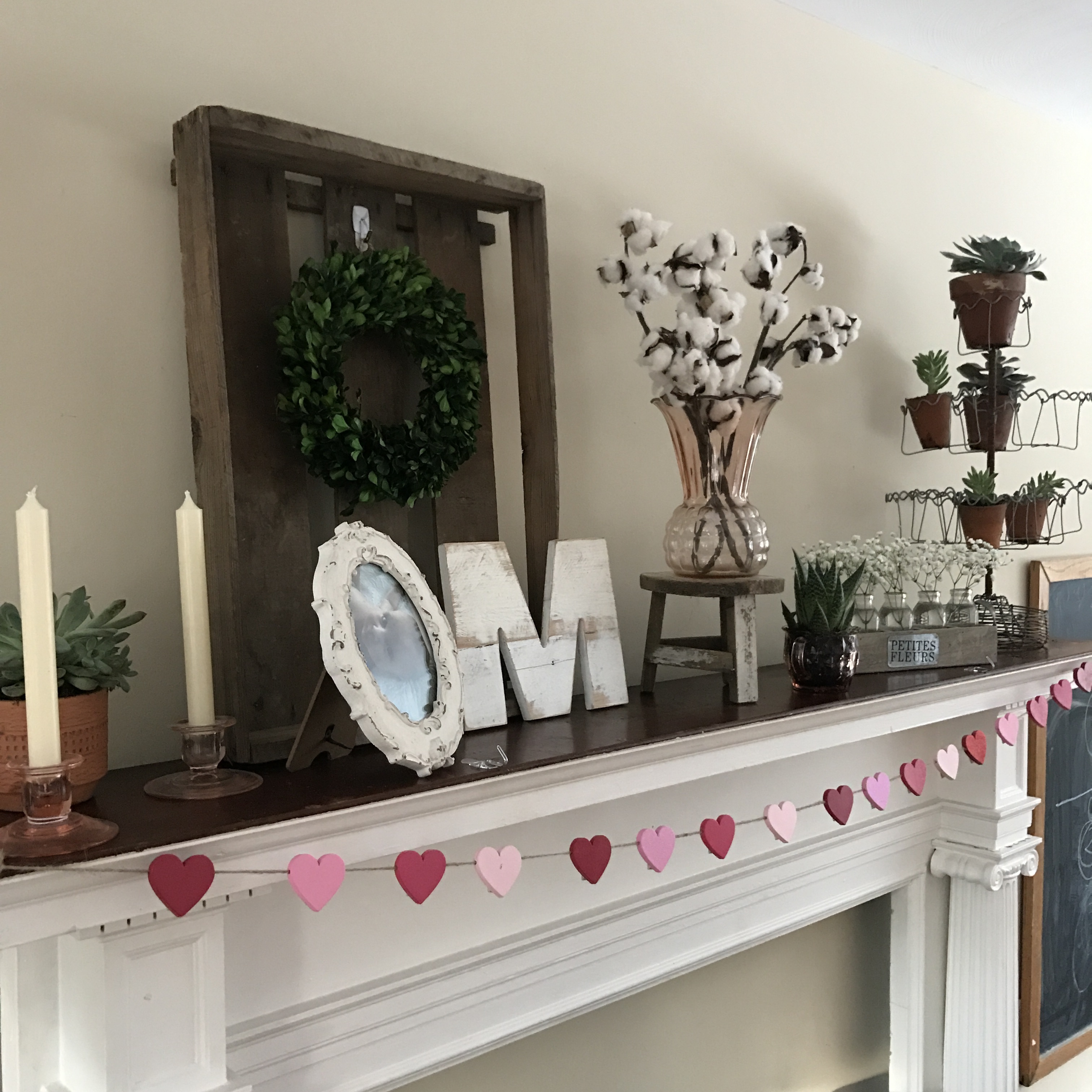Winter to Spring transitional mantel Farmhouse decor, succulents, terra cotta, pink depression glass, Magnolia Market, Harp Designs, boxwood wreath, monogram, baby's breath, farmhouse mantel - From the Family With Love