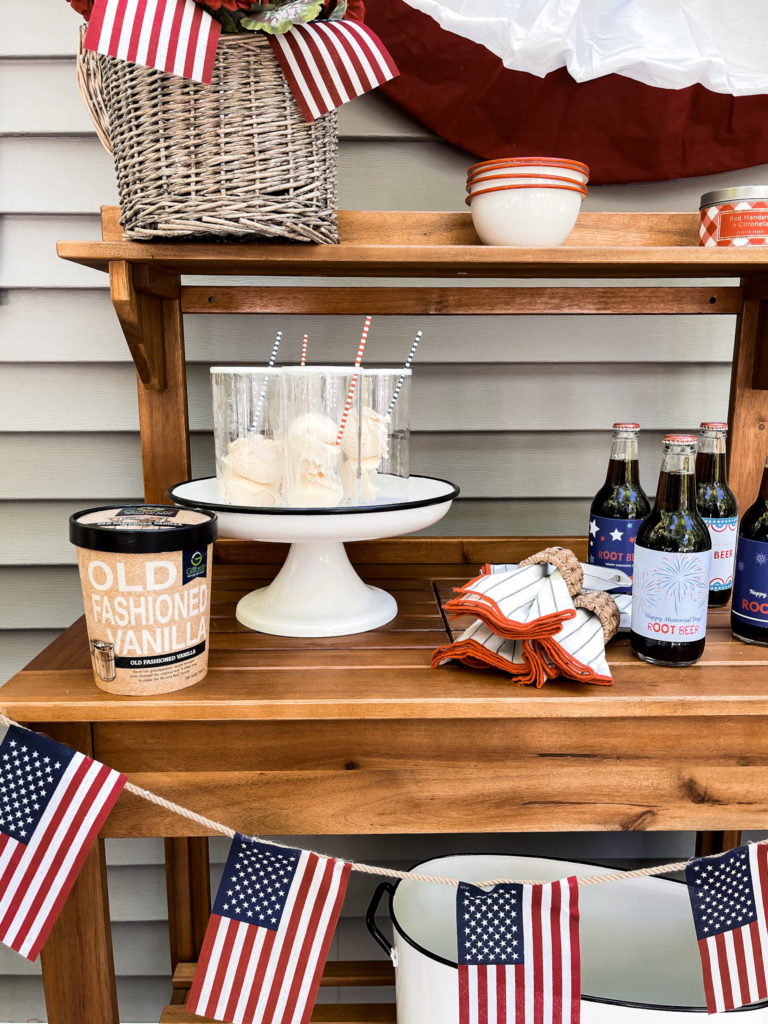 quart of vanilla ice cream with root beer float and American flag banner and patriotic labels on root beer bottles