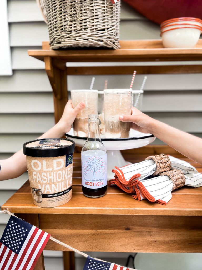 quart of vanilla ice cream with root beer float and American flag banner and patriotic labels on root beer bottles