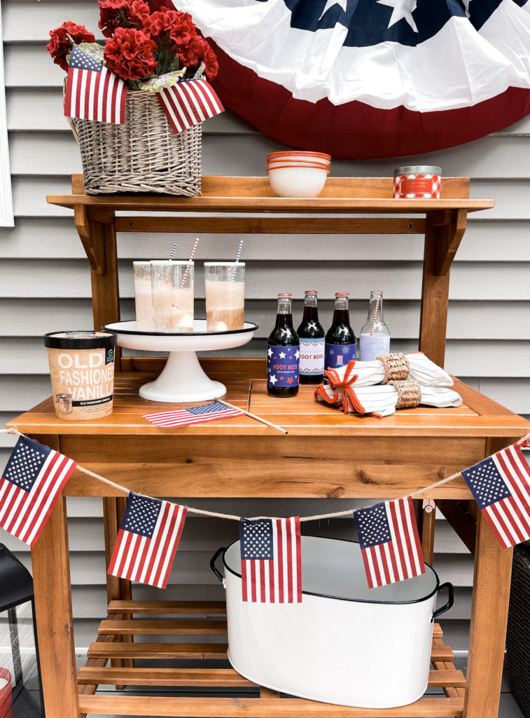 quart of vanilla ice cream with root beer float and American flag banner and patriotic labels on root beer bottles